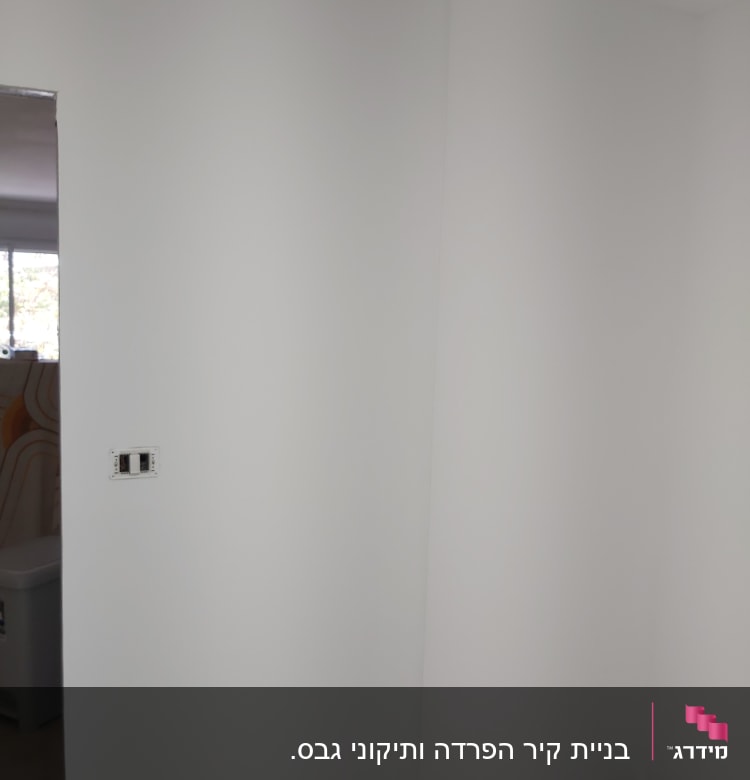 קיר גבס לבן עם שקע חשמל